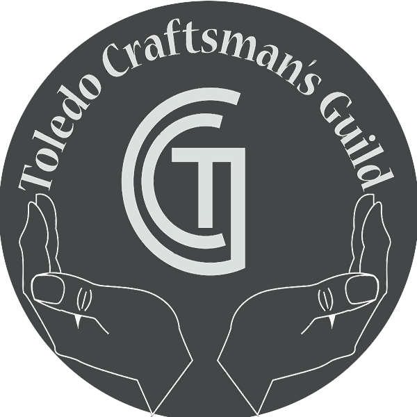 Two hands holding a circular logo with text 'Toledo Craftsman's Guild' and a stylized 'G' in the center.
