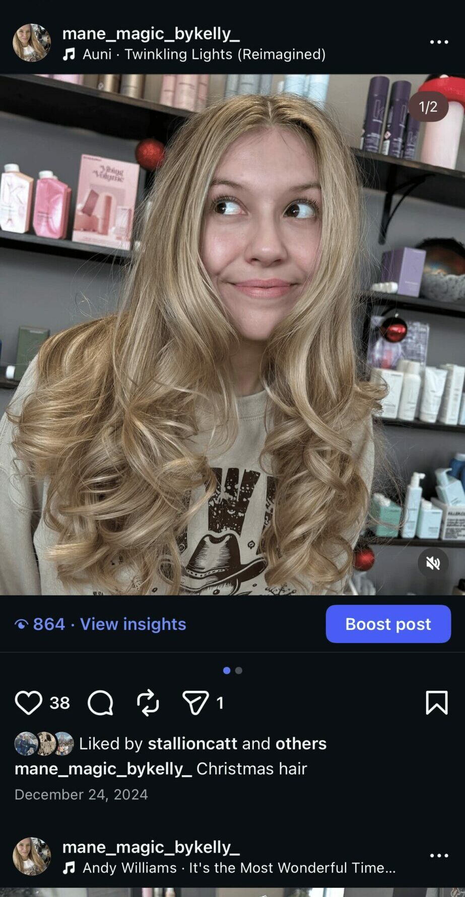 Young woman with long, wavy blonde hair smiling in a store with shelves of products behind her.