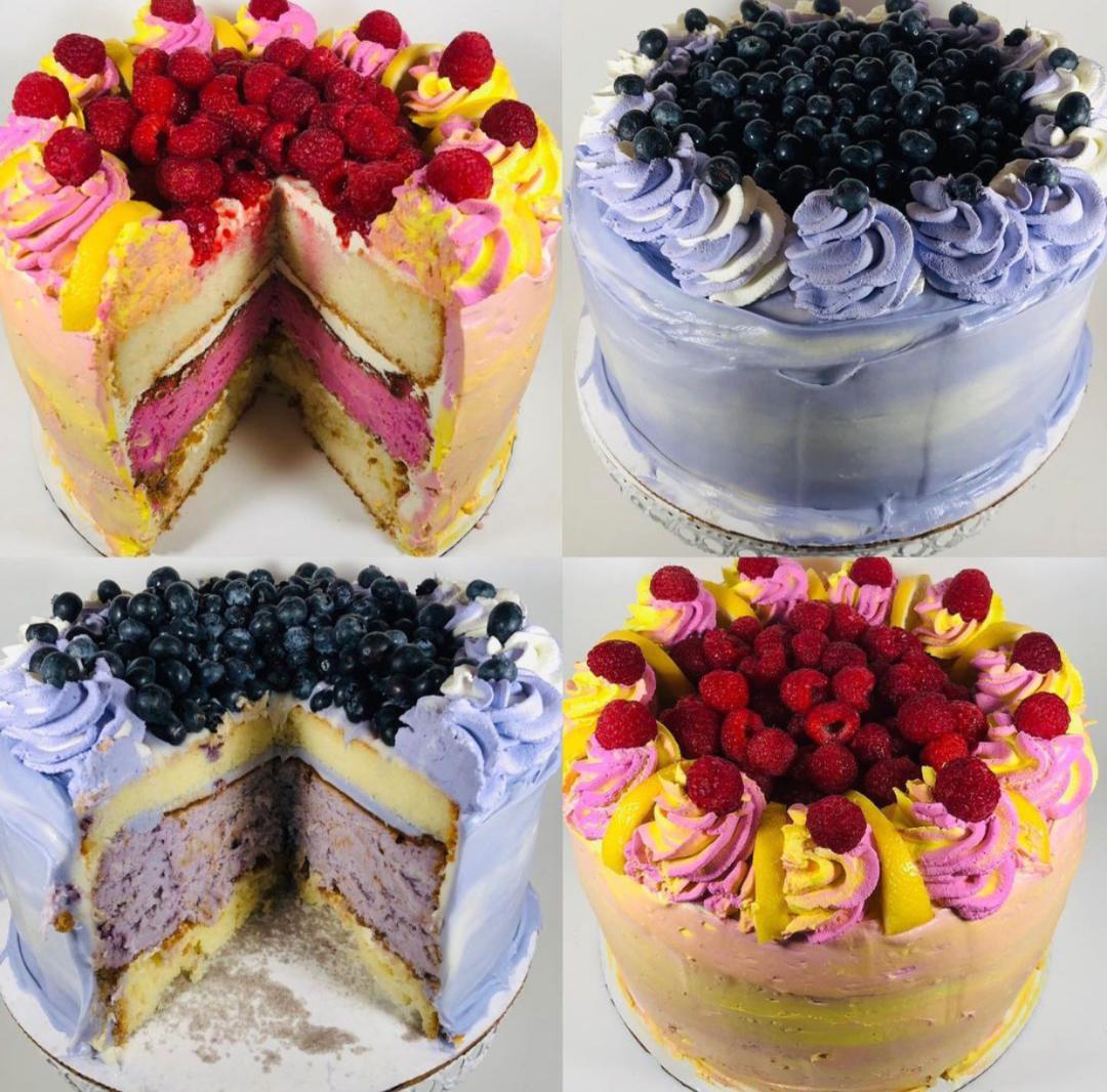 Four cakes with colorful frosting and berries, two with slices removed showing layers, on a white background.