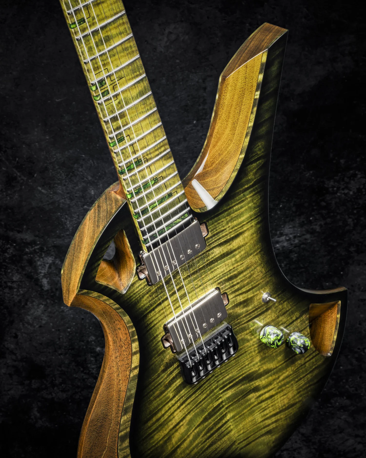 Electric guitar with a greenish-yellow striped finish and wooden accents, set against a dark background.