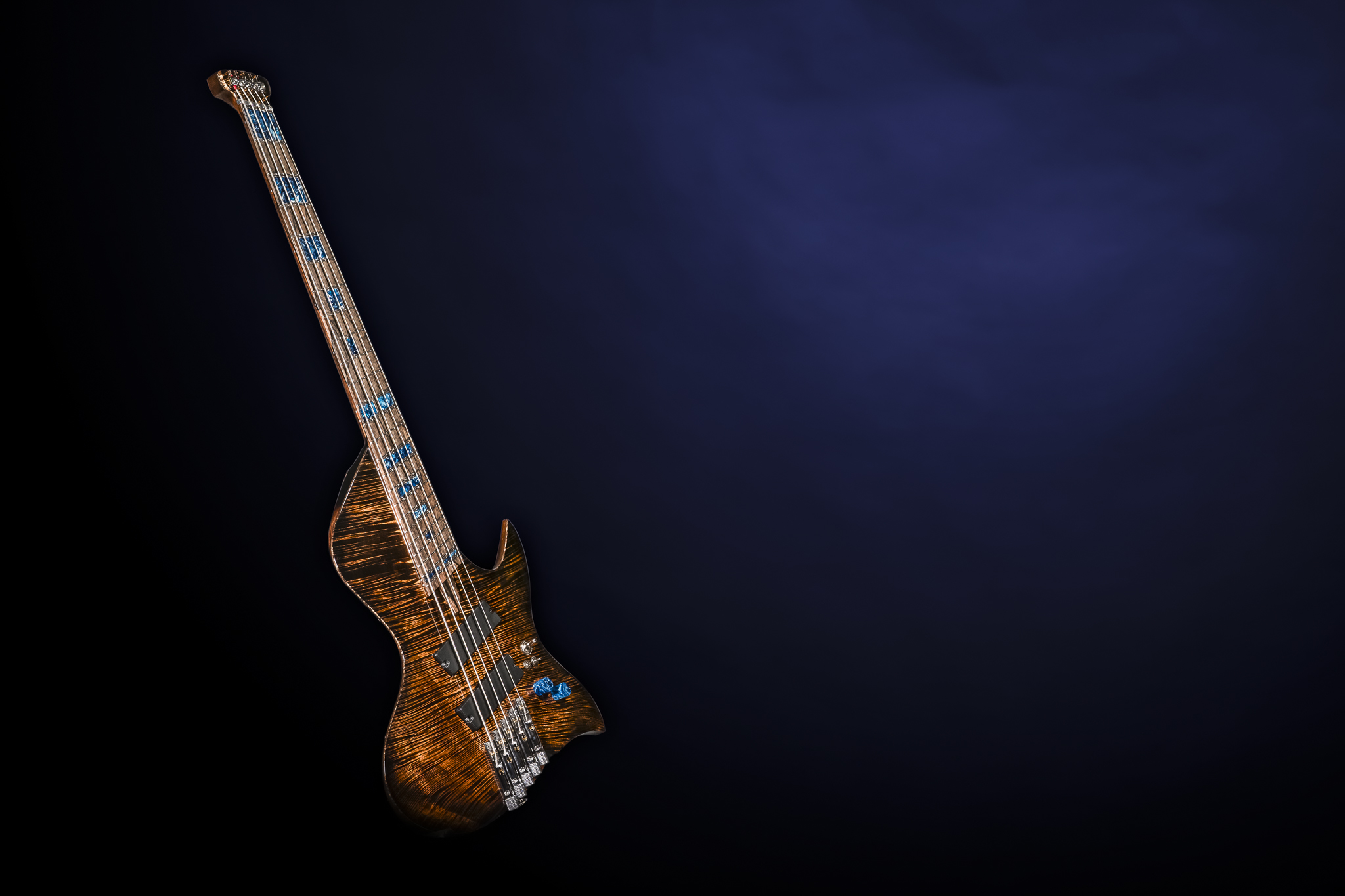 Electric guitar leaning against a dark blue background, with a wooden body and neck, and blue accents.