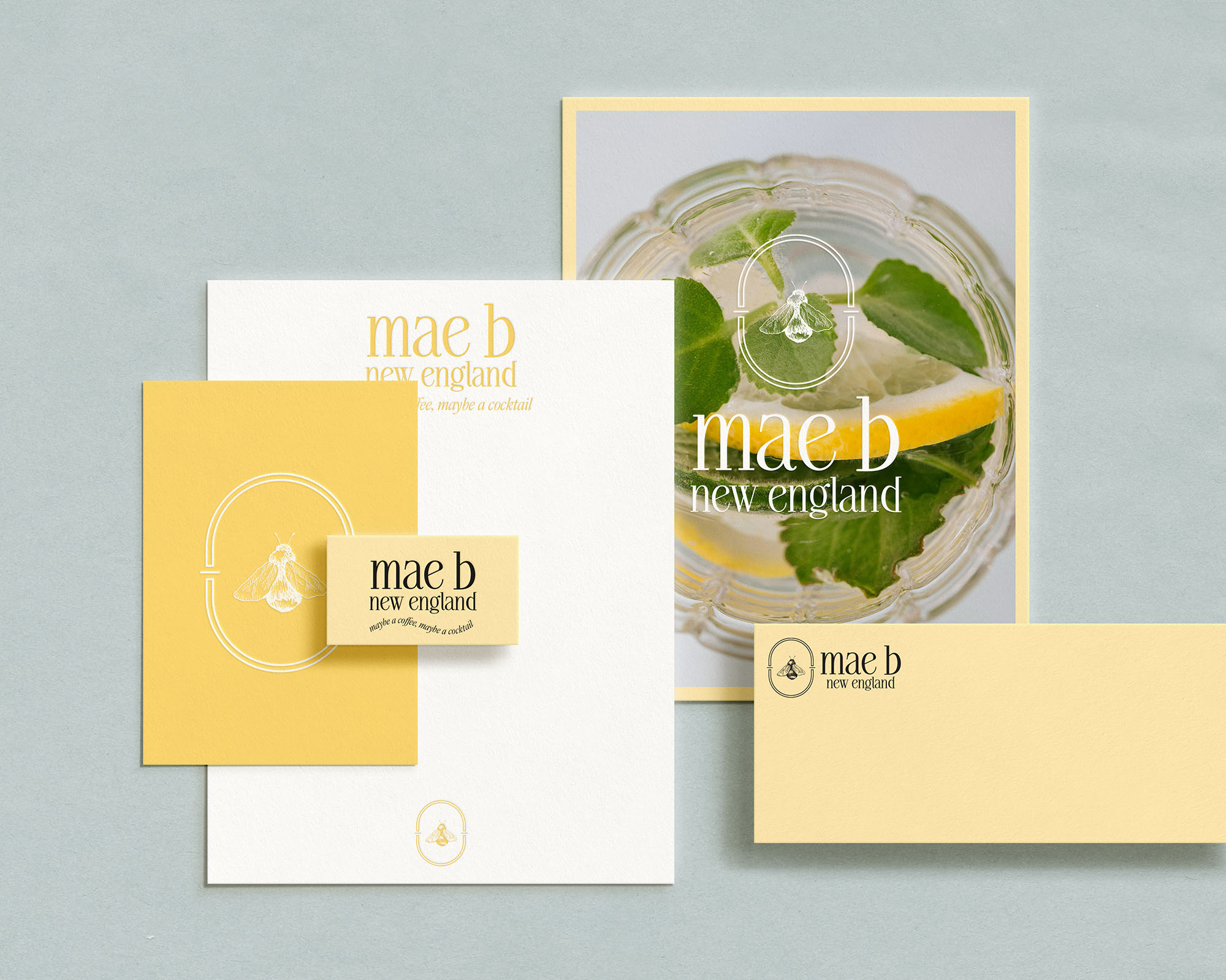 Set of branding materials with yellow, white, and clear elements, including a drink with mint and lemon, on a light background.