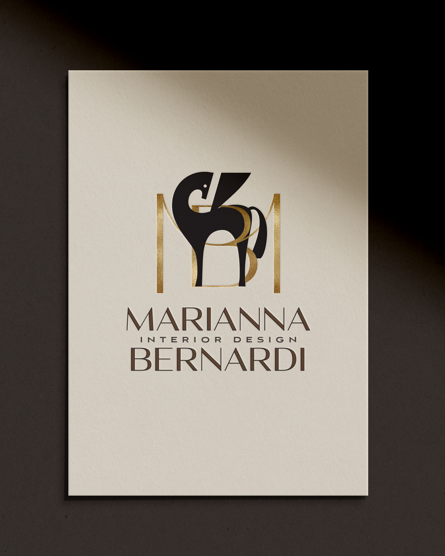 Logo with stylized black and gold design, text reads 'MARIANNA INTERIOR DESIGN BERNARDI', on a white background.