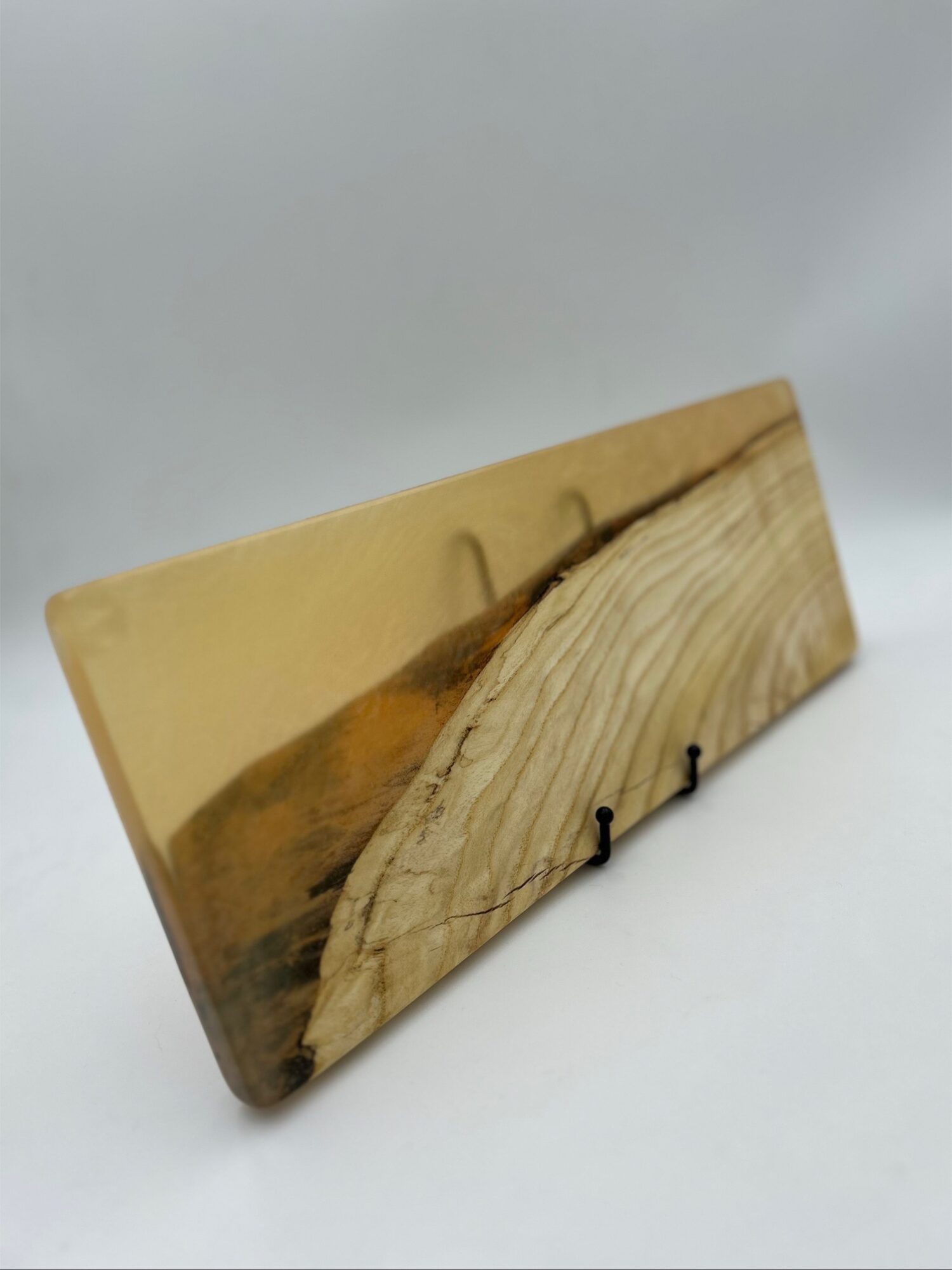 Wooden plaque with a landscape painting of a tree and a wooden dock, mounted on a white background.