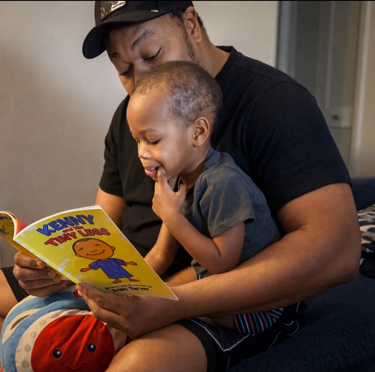 Adult and child reading a colorful children's book together, sitting indoors, smiling and engaging with the story.
