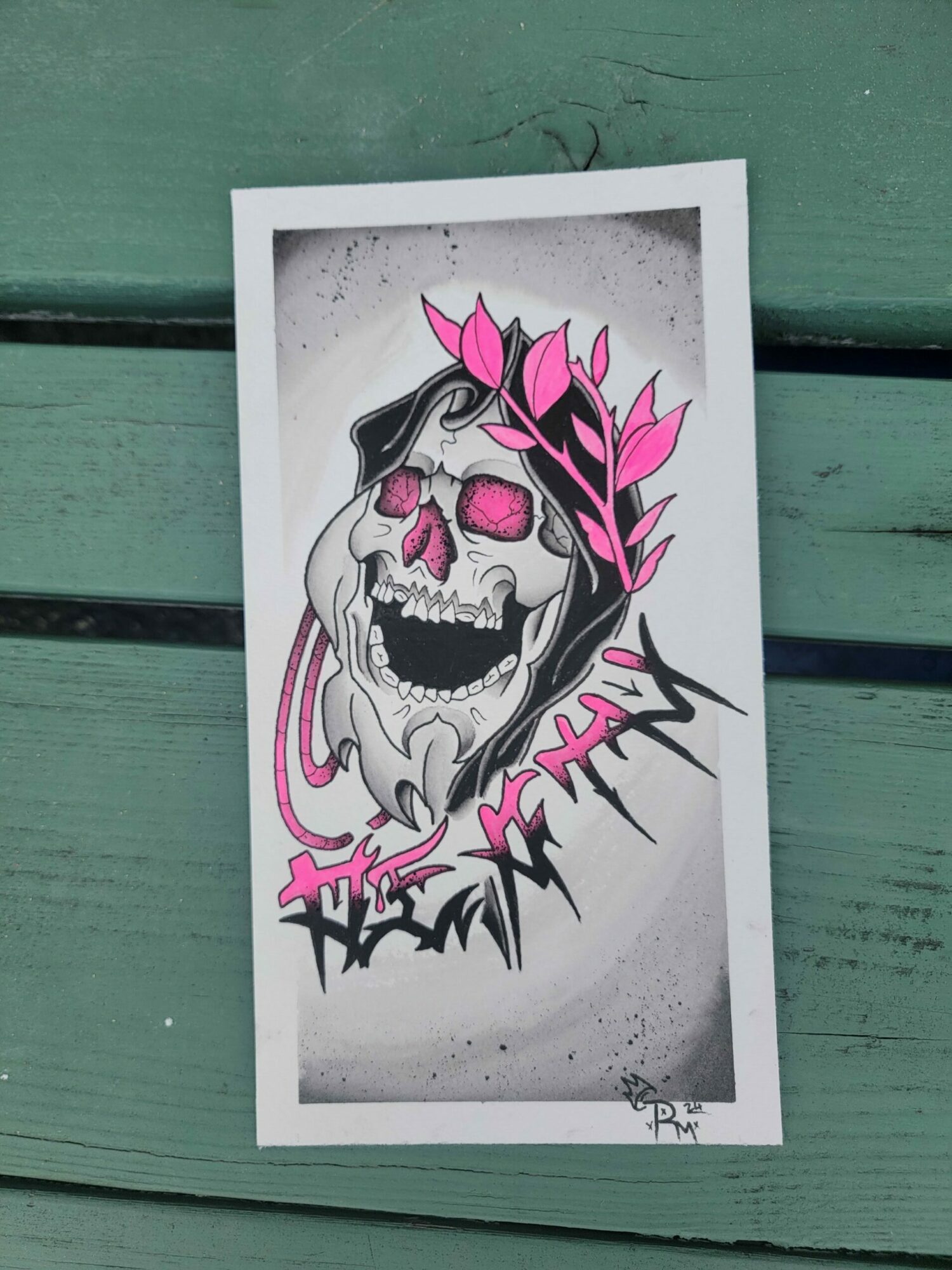 A colorful skull with pink leaves and abstract lines, with stylized text and a gray background.