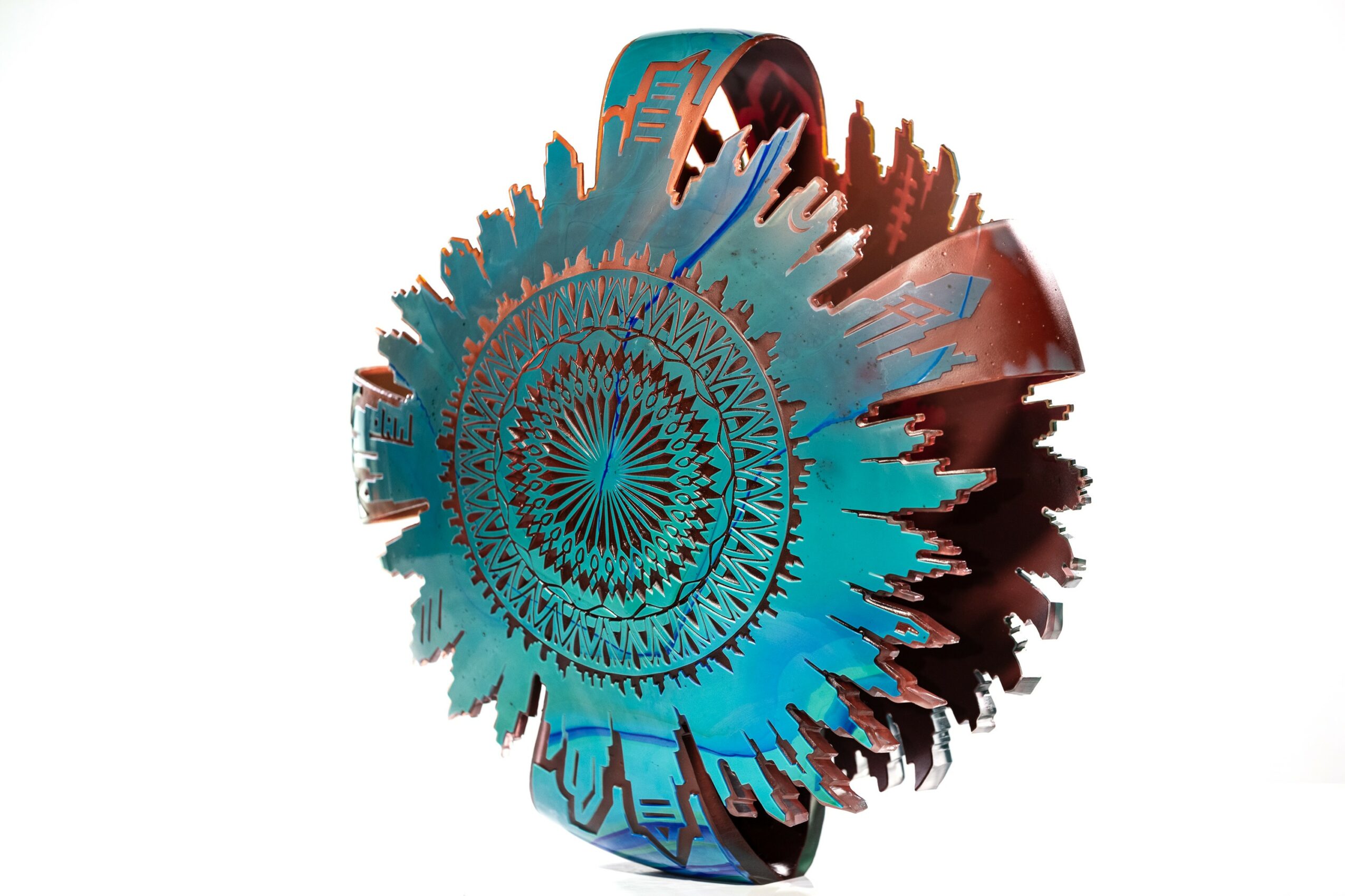 Colorful abstract circular design with intricate patterns and jagged edges, resembling a stylized gear or mandala, on a white background.