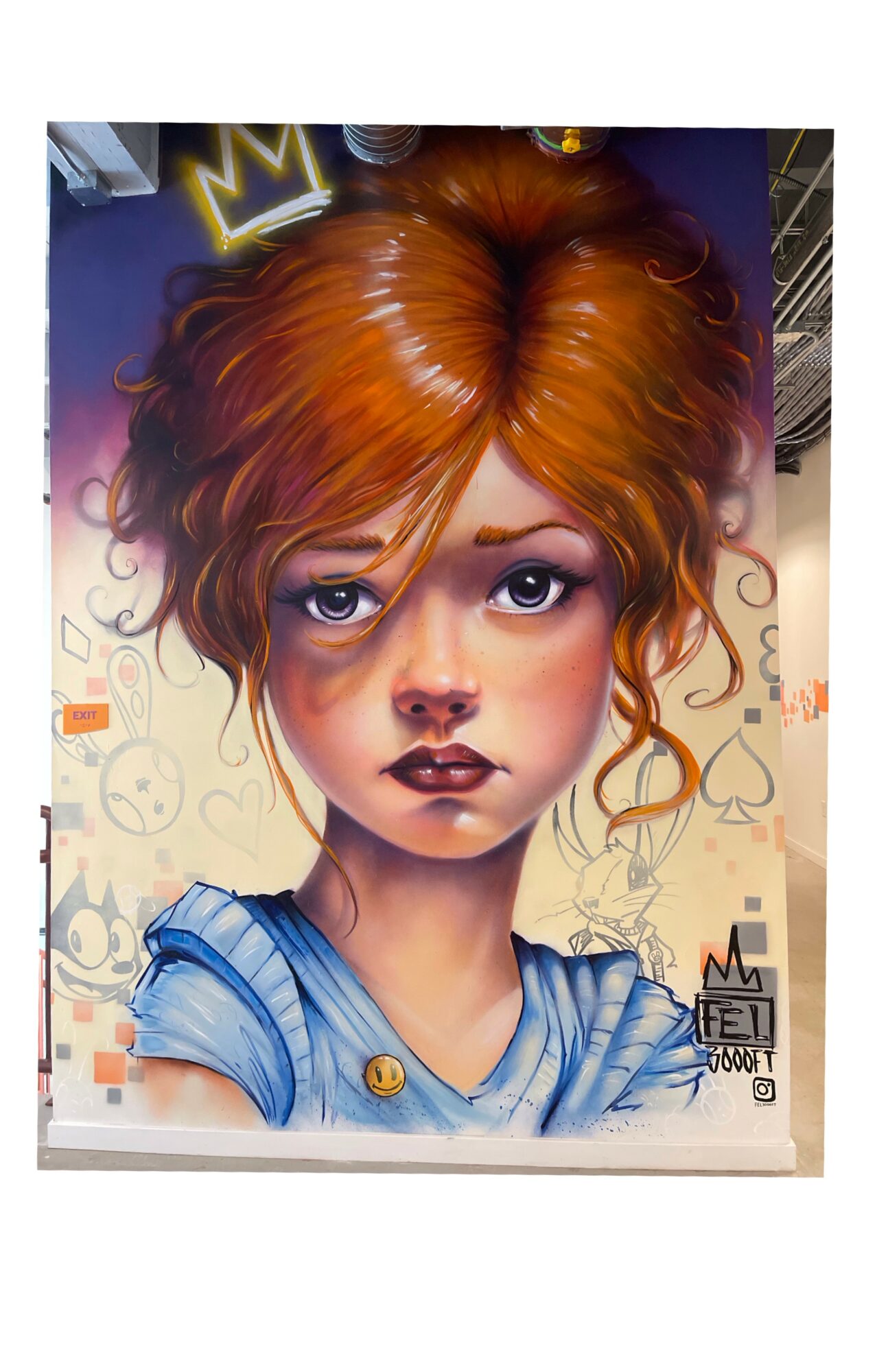 Portrait of a young girl with curly red hair, large eyes, and a serious expression, wearing a blue top.
