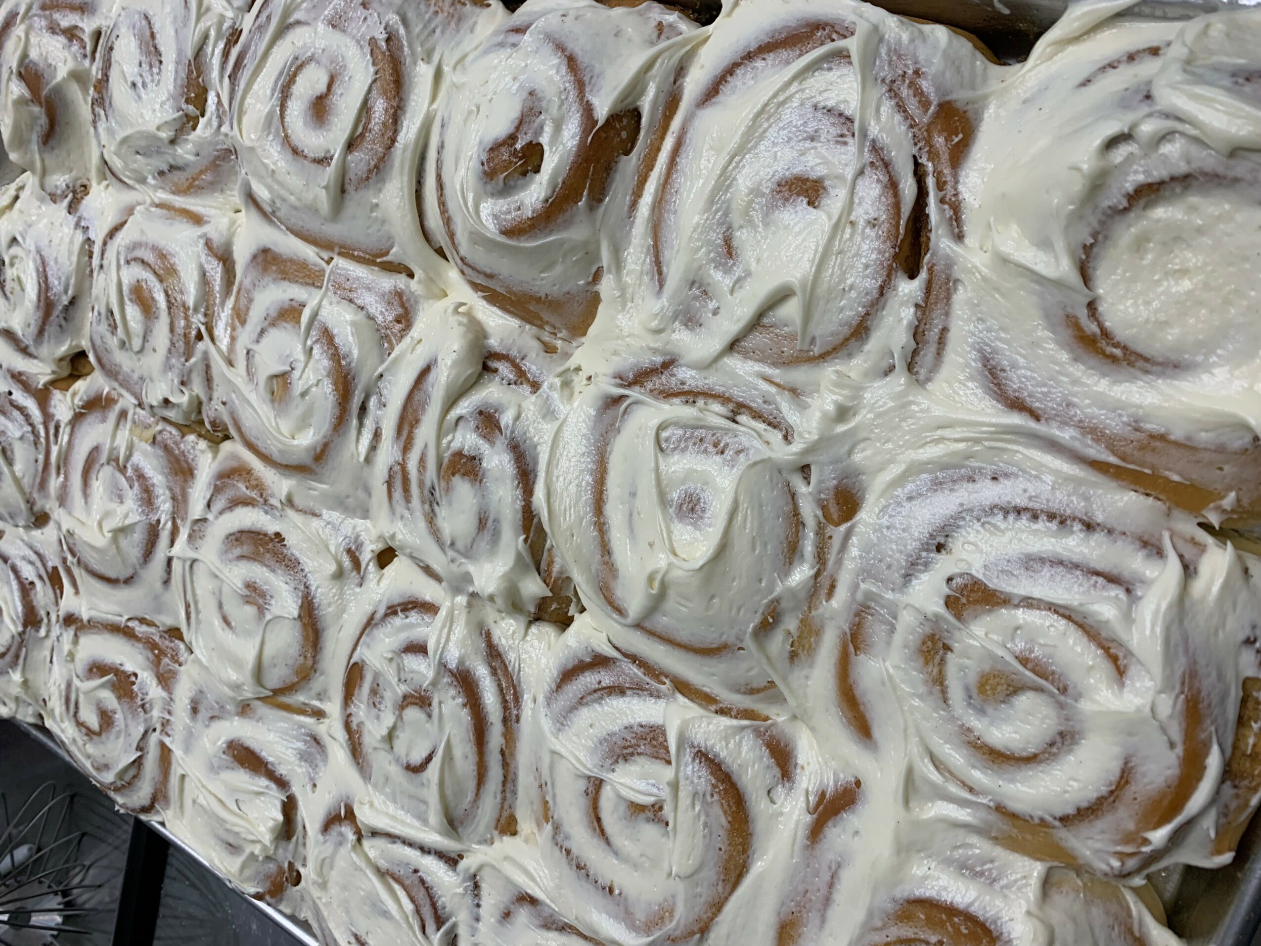 Close-up of a textured surface with numerous swirling, spiral-like patterns in shades of white and beige.