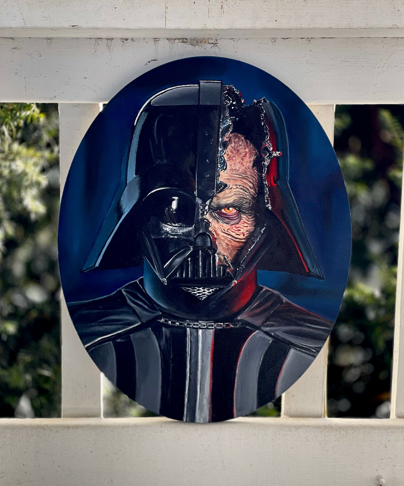 Oval image of Darth Vader's helmet with a half-zombie face behind it, set outdoors with trees in the background.
