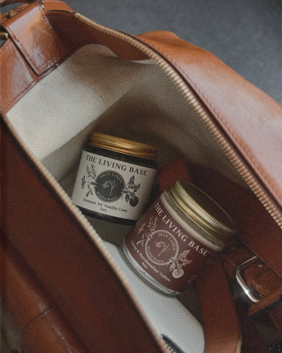 Open bag showing two jars labeled 'The Living Basil' inside, with a zipper and fabric lining visible.