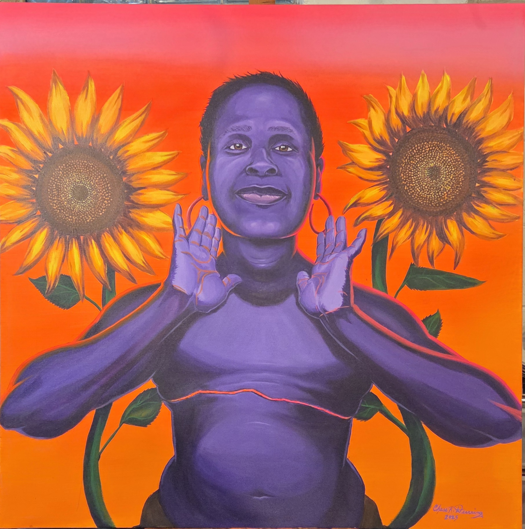 Portrait of a person with purple skin, short hair, and large earrings, surrounded by two sunflowers against an orange background.
