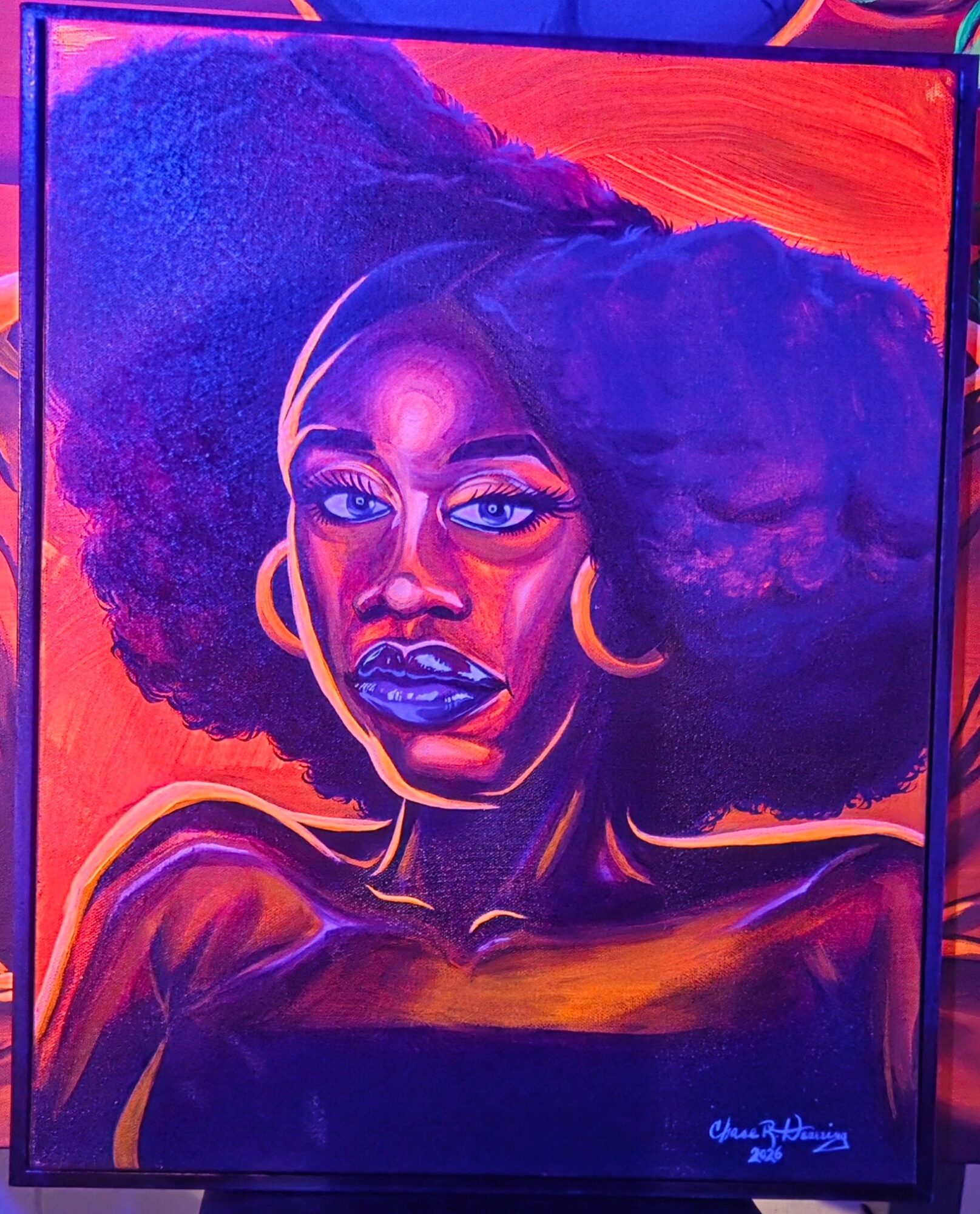 Portrait of a woman with large afro hairstyle, wearing hoop earrings, with bold makeup, against a vibrant background.