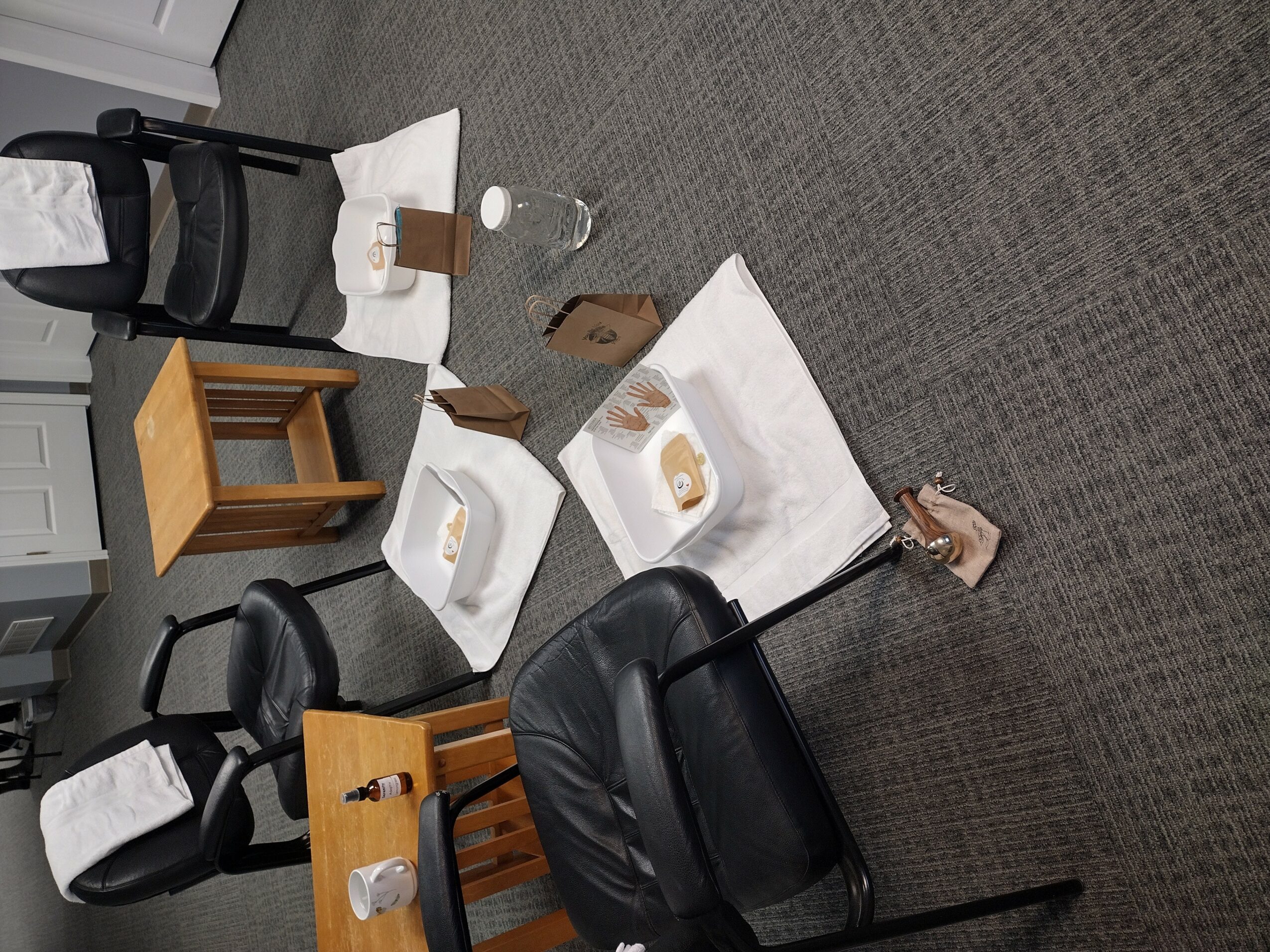 Office with chairs, tables, and items on the floor, including a shoe, glasses, and paper, viewed from the side.