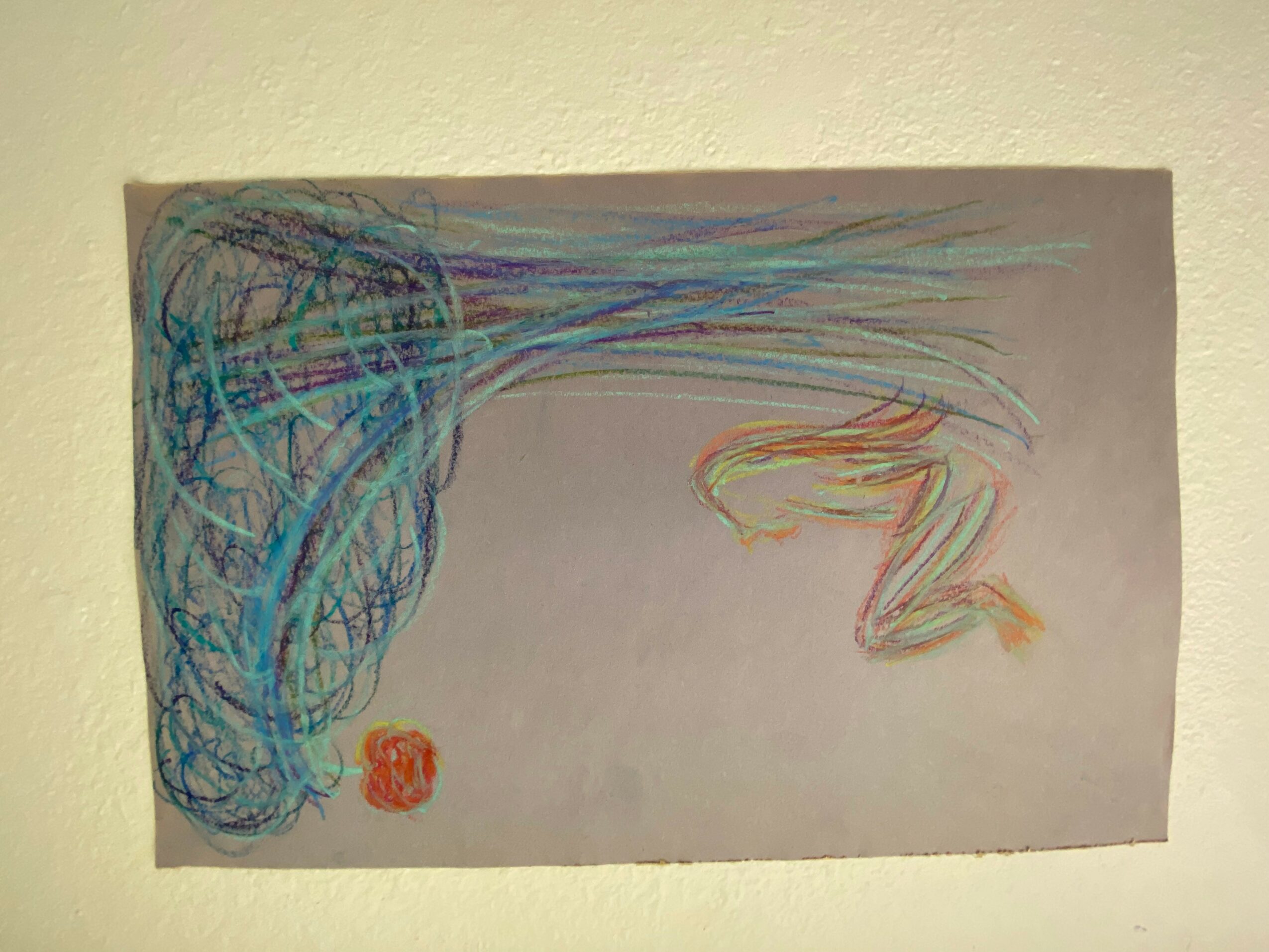 Colorful scribbles on the left side with a red stamp, fading to a plain background on the right.