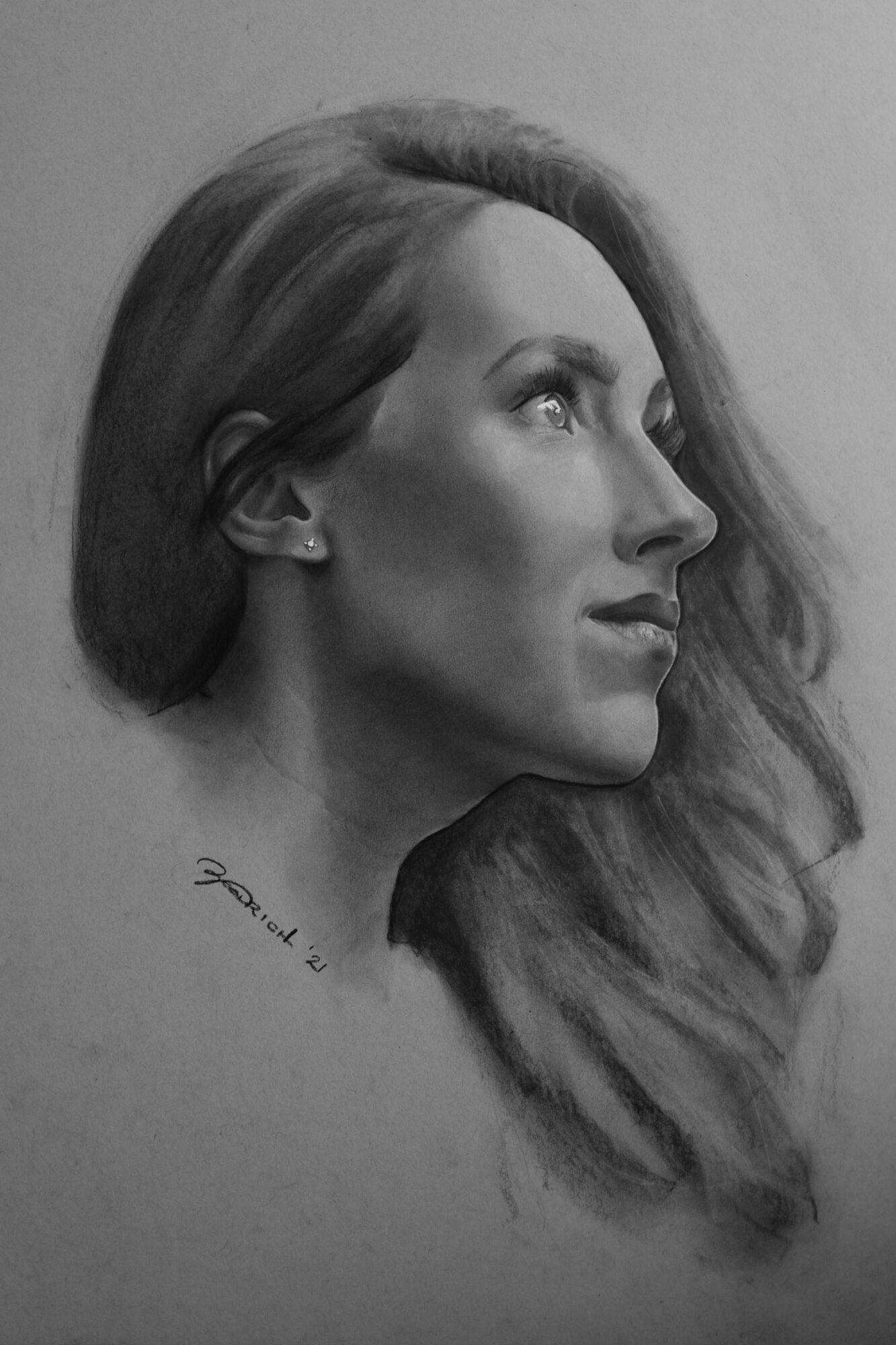 Side profile of a woman with long hair, detailed shading, and a neutral background.