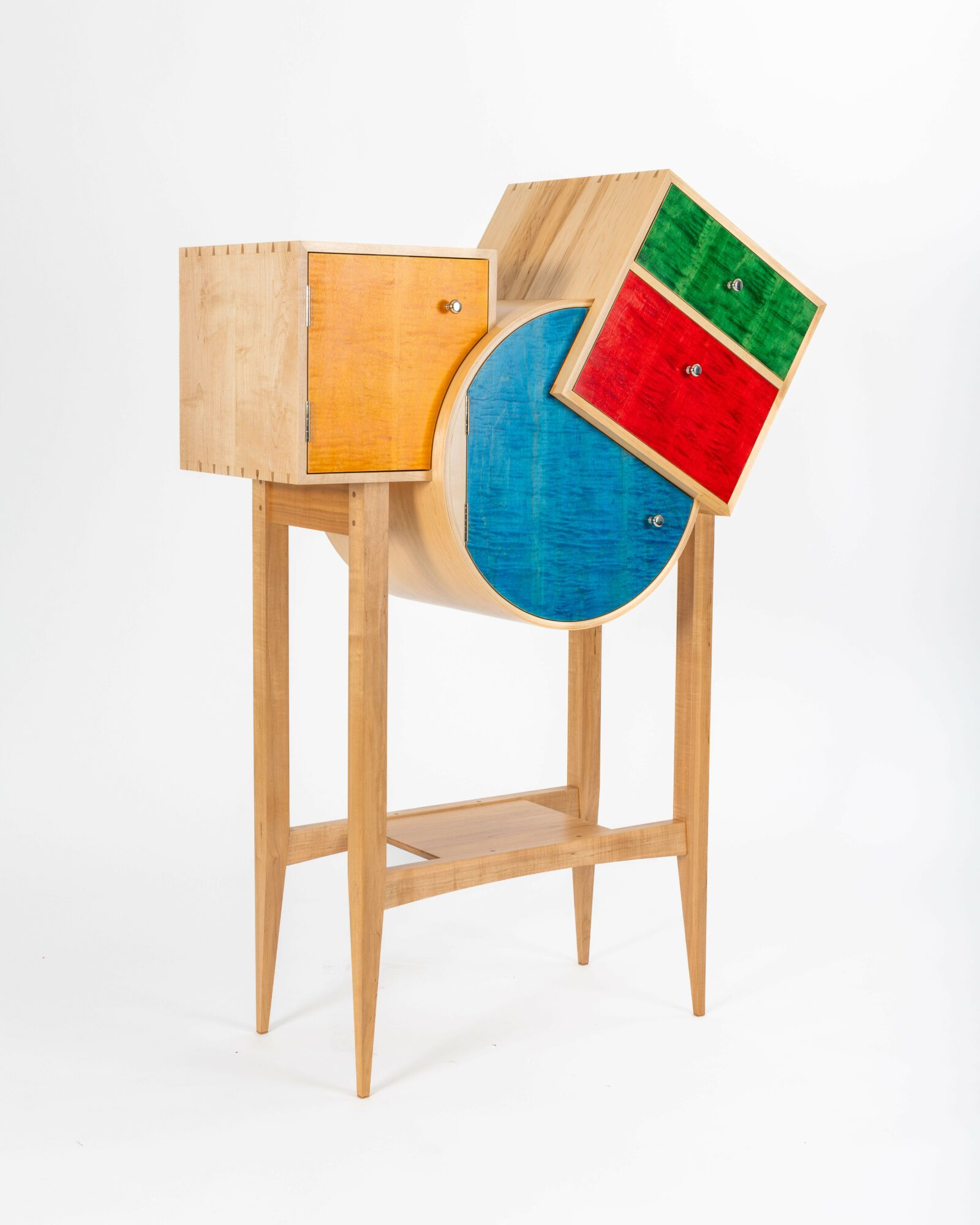 Wooden cabinet with colorful geometric shapes and patterns, standing on four legs against a white background.