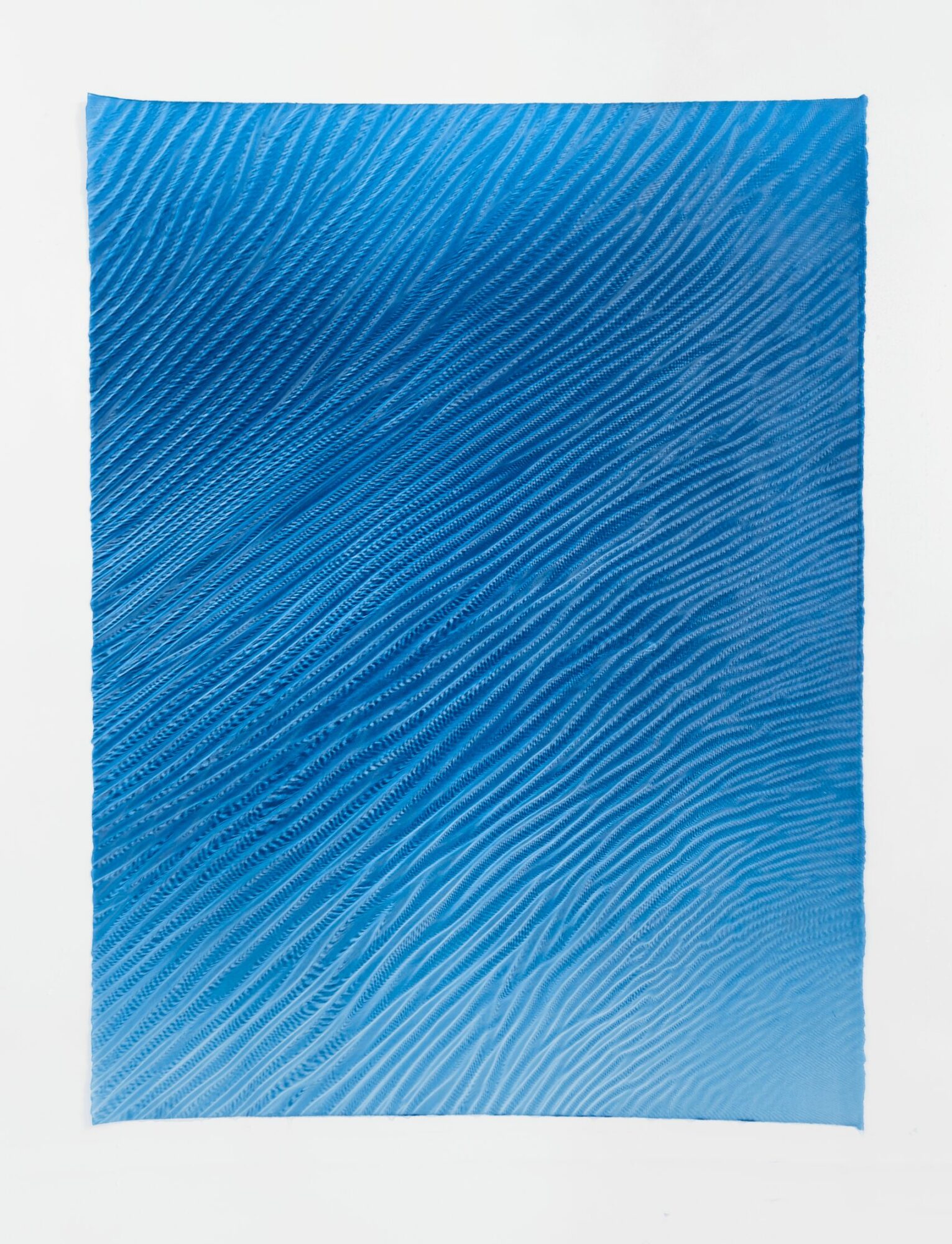 Blue textured paper with diagonal lines, slightly curled at edges.