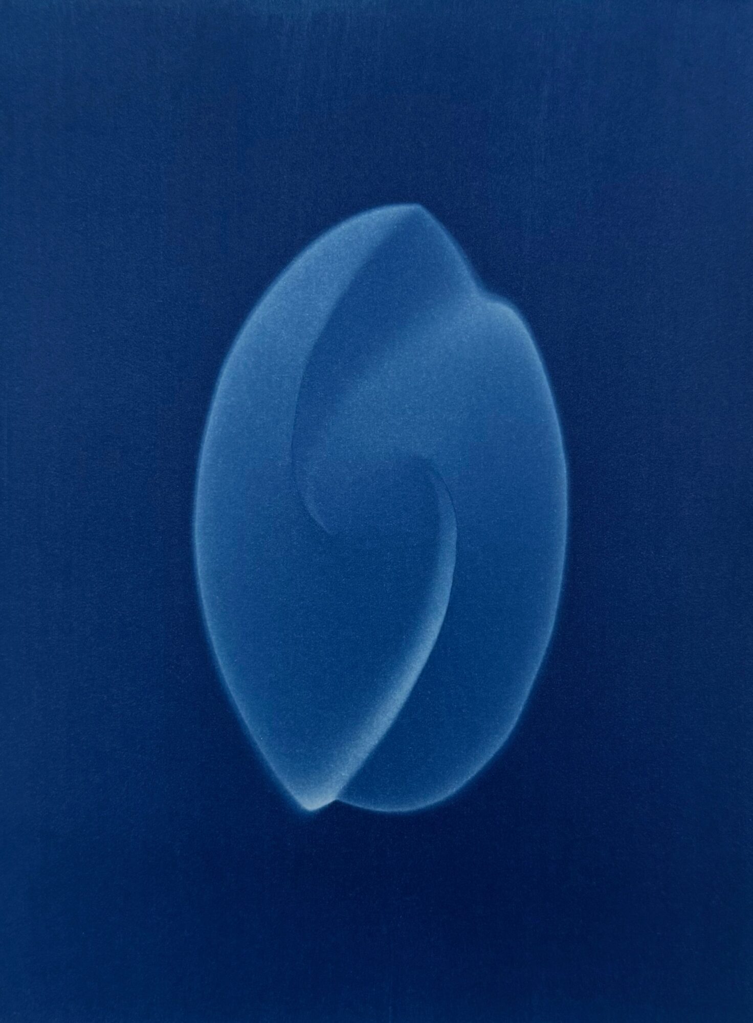 Close-up of a blue, spiral-shaped object against a dark background.