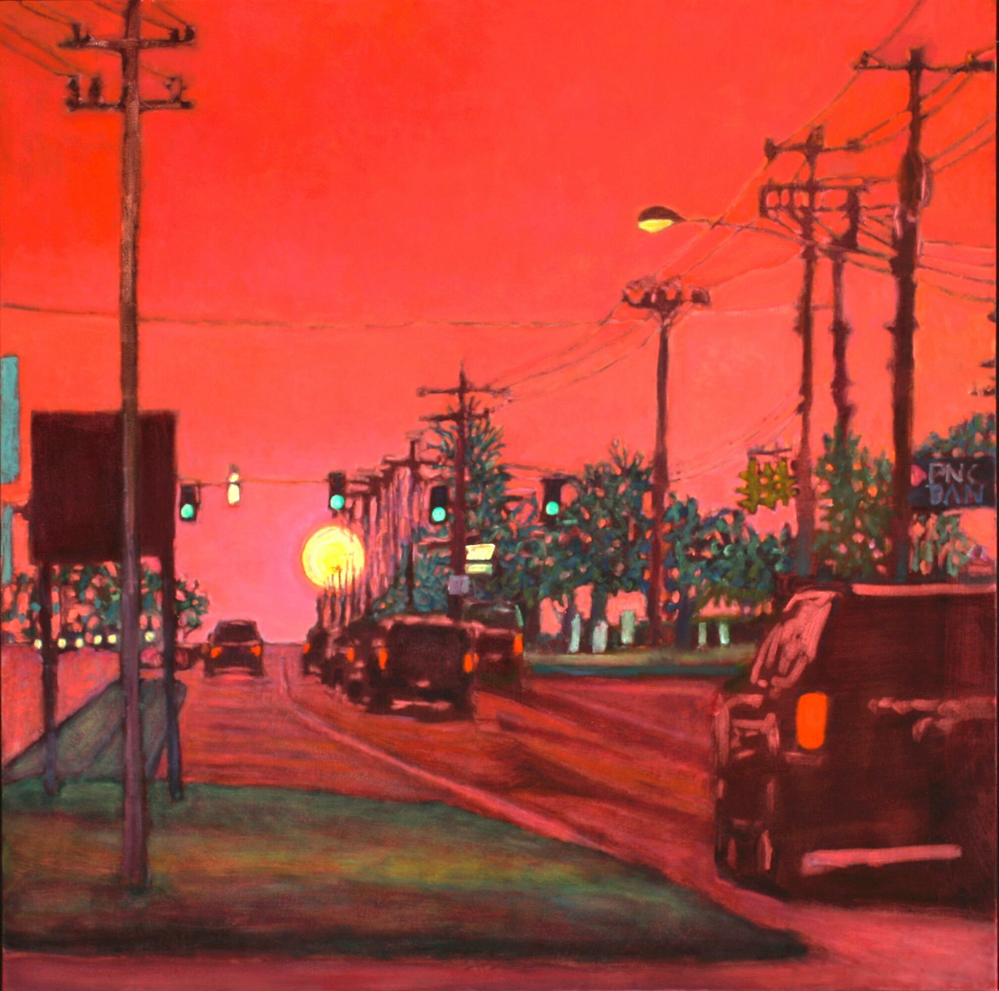 Sunset over a street with cars, utility poles, and trees, sky painted in shades of pink and orange.
