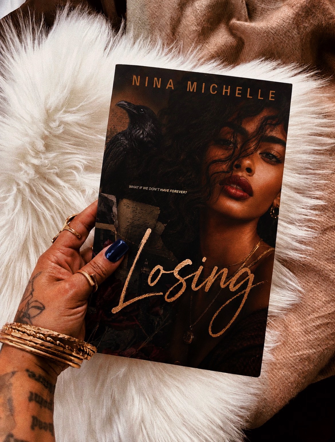 Book cover titled 'Losing' by Nina Michelle, featuring a woman with dark curly hair and a black cat, on a fluffy white surface.