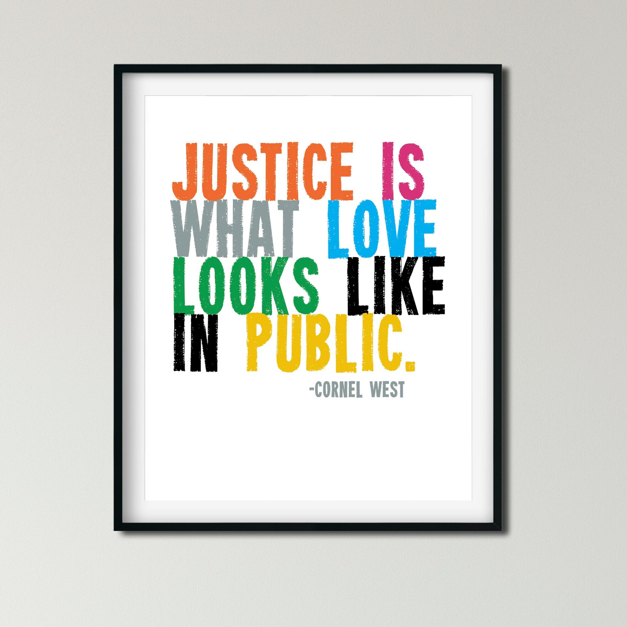 Framed poster with colorful text quote about justice, love, and public opinion, attributed to Cornel West, on a light wall.