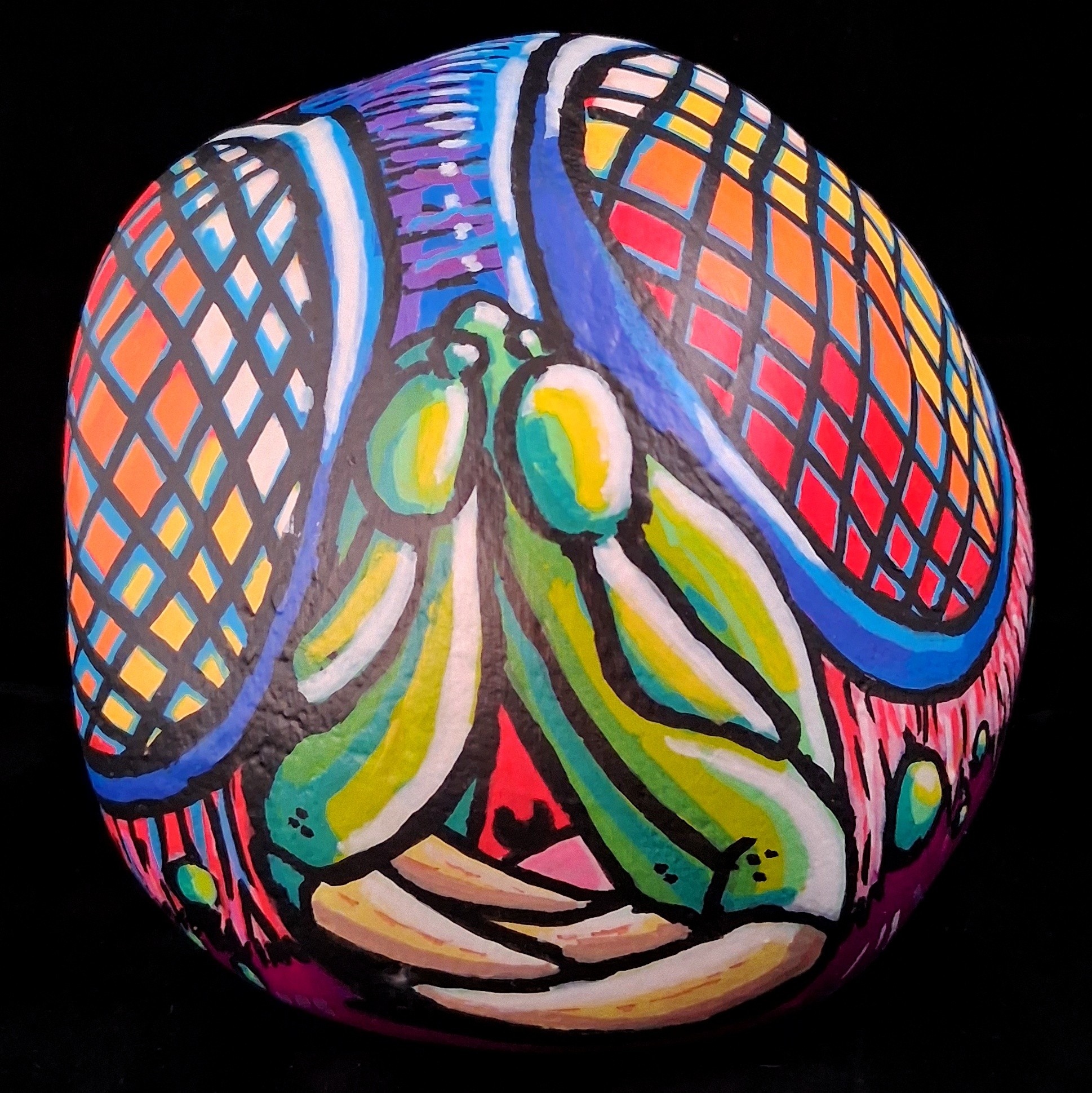 Colorful abstract painting on a spherical surface with grid patterns and organic shapes, set against a black background.