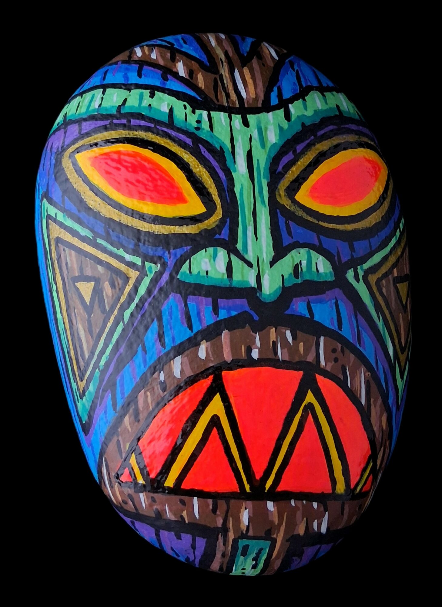 Colorful tribal mask with large eyes, open mouth, and intricate patterns, set against a black background.