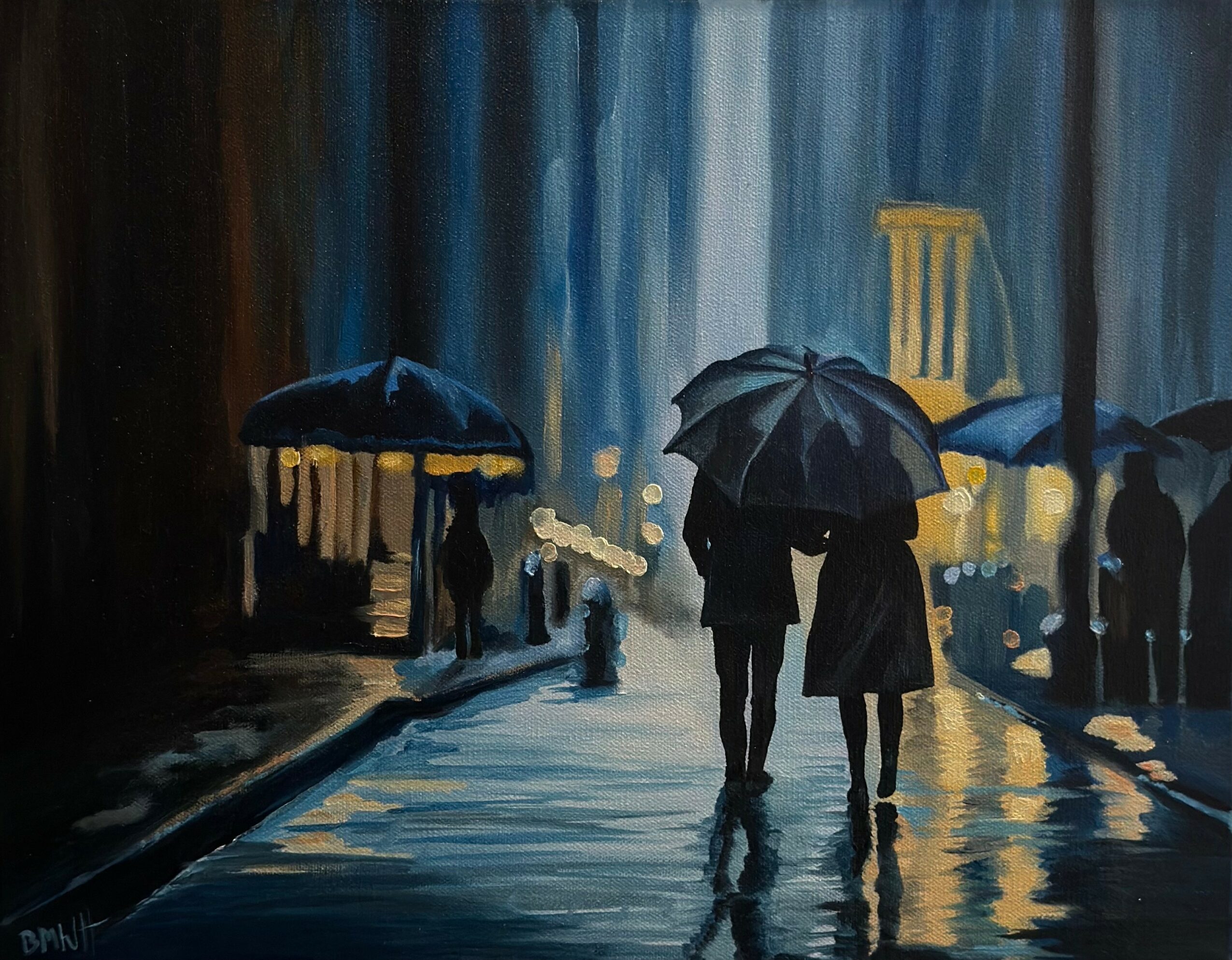 Two people walk with umbrellas on a rainy city street at night, illuminated by streetlights and building lights.