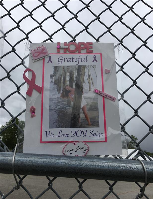 Memorial poster with a photo of a person walking on a bridge, surrounded by pink ribbons and messages of gratitude and love.