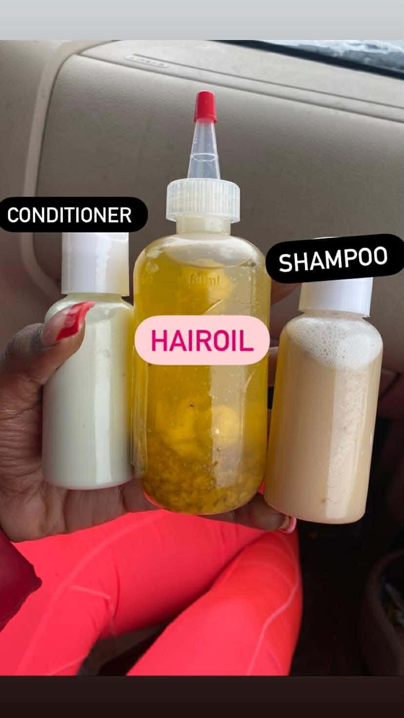 Hand holding three bottles labeled conditioner, shampoo, and hair oil inside a vehicle, with dashboard in background.