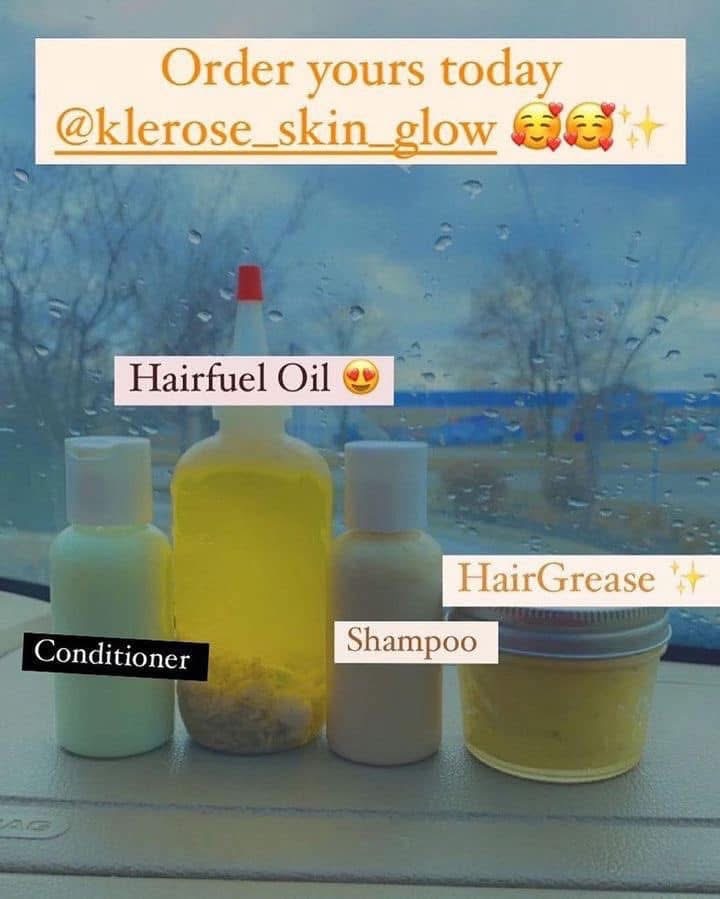 View of hair care products on a windowsill with rain outside, including conditioner, shampoo, and hair oil bottles.