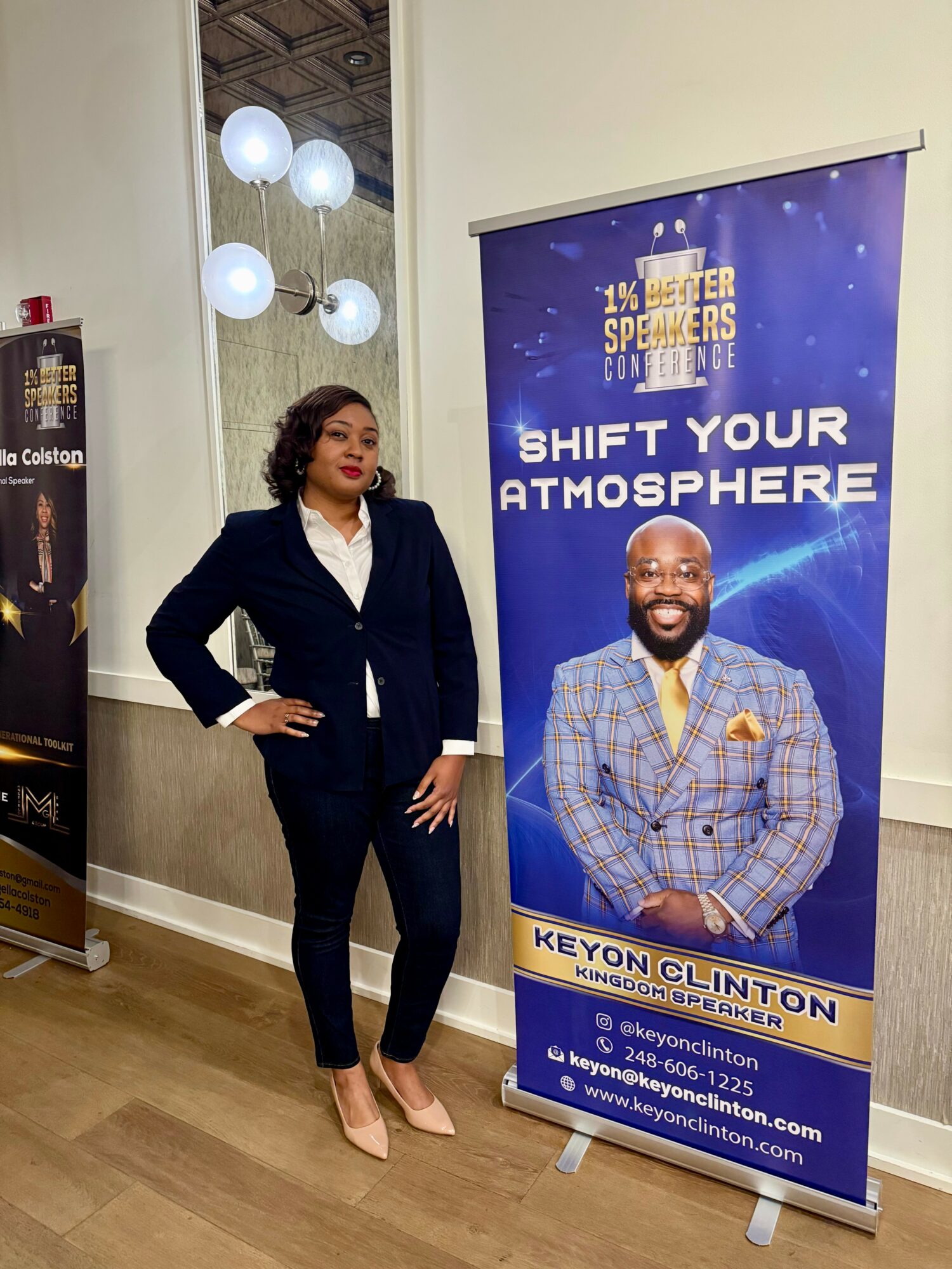 Woman in a dark suit standing next to a blue banner with a smiling man in a plaid blazer, text about shifting atmosphere.