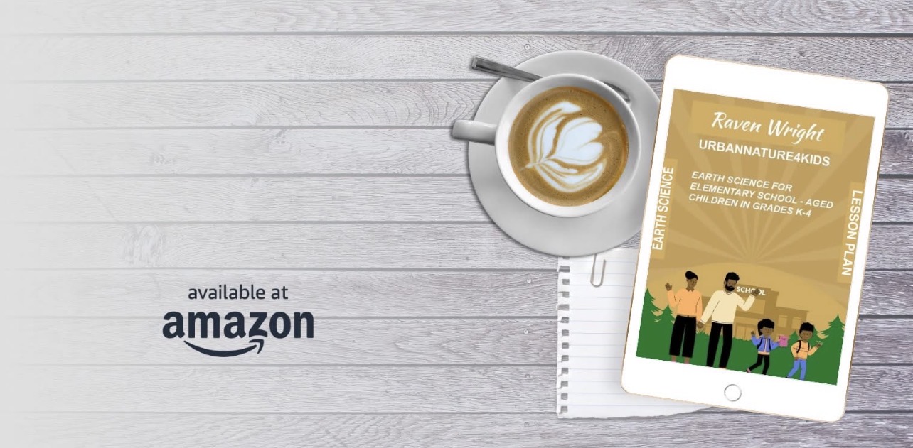 A tablet displaying a book cover, a cup of coffee with latte art, and a ruler on a white wooden surface.