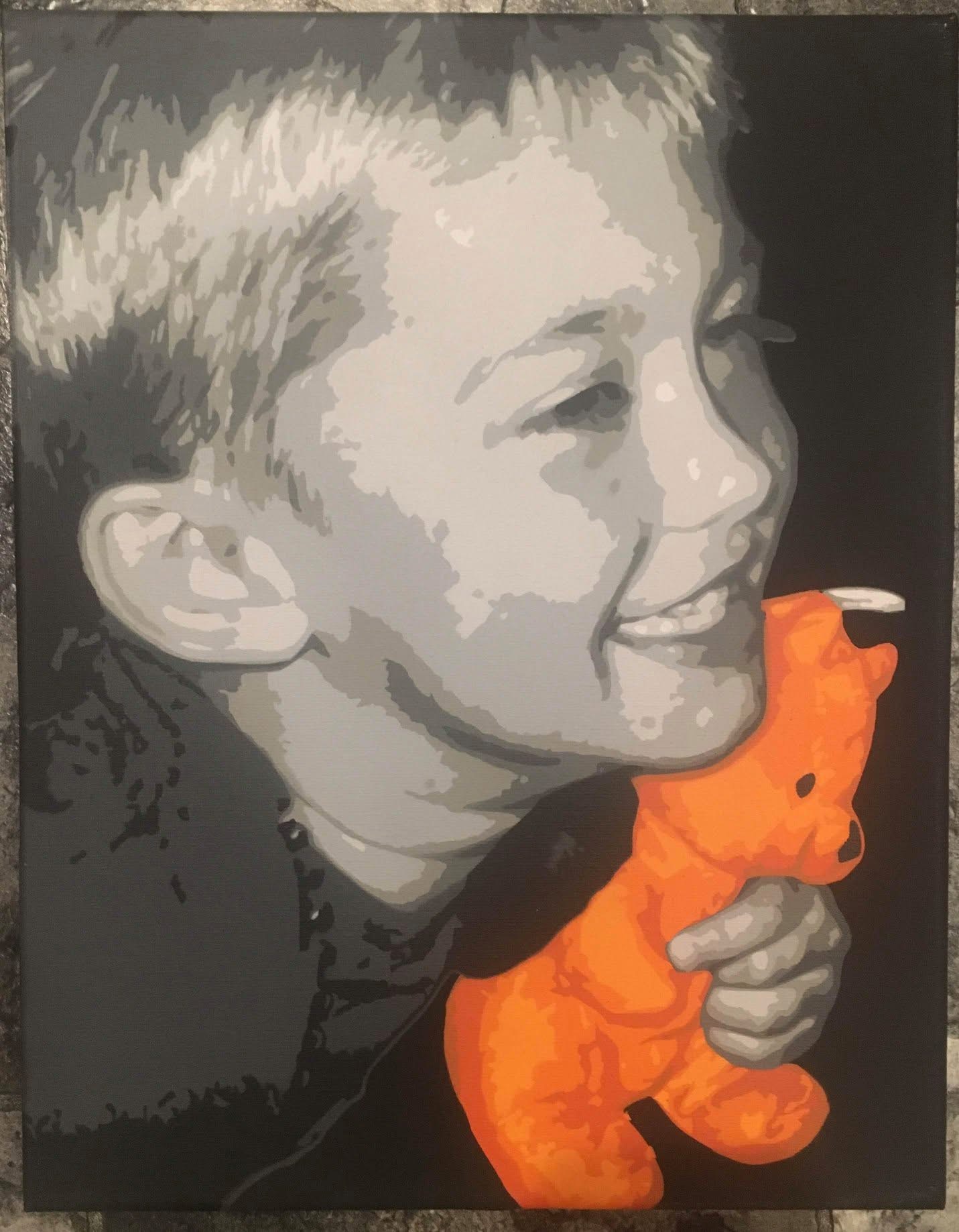 Child smiling and holding an orange stuffed animal, facing right, in grayscale with a dark background.