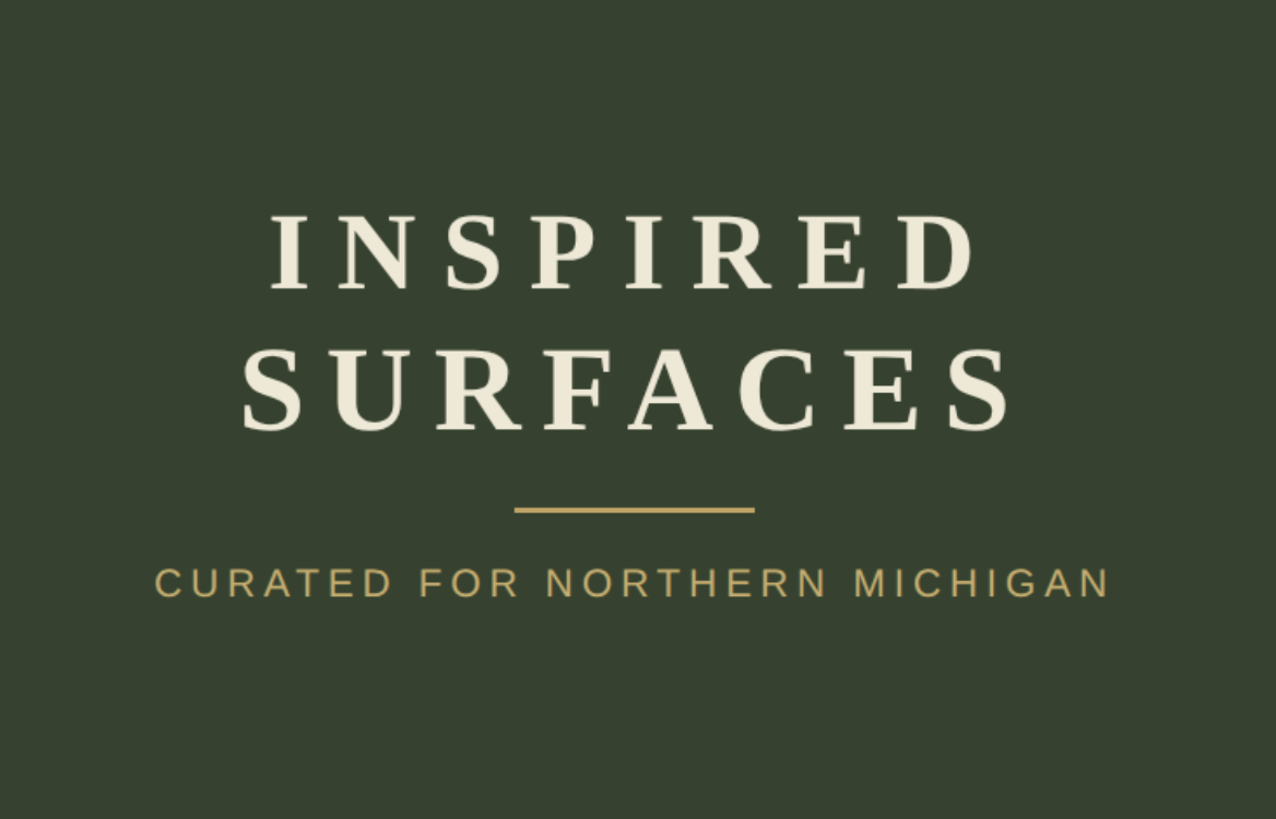 Text reads 'Inspired Surfaces' with smaller text 'Curated for Northern Michigan' on a dark green background.