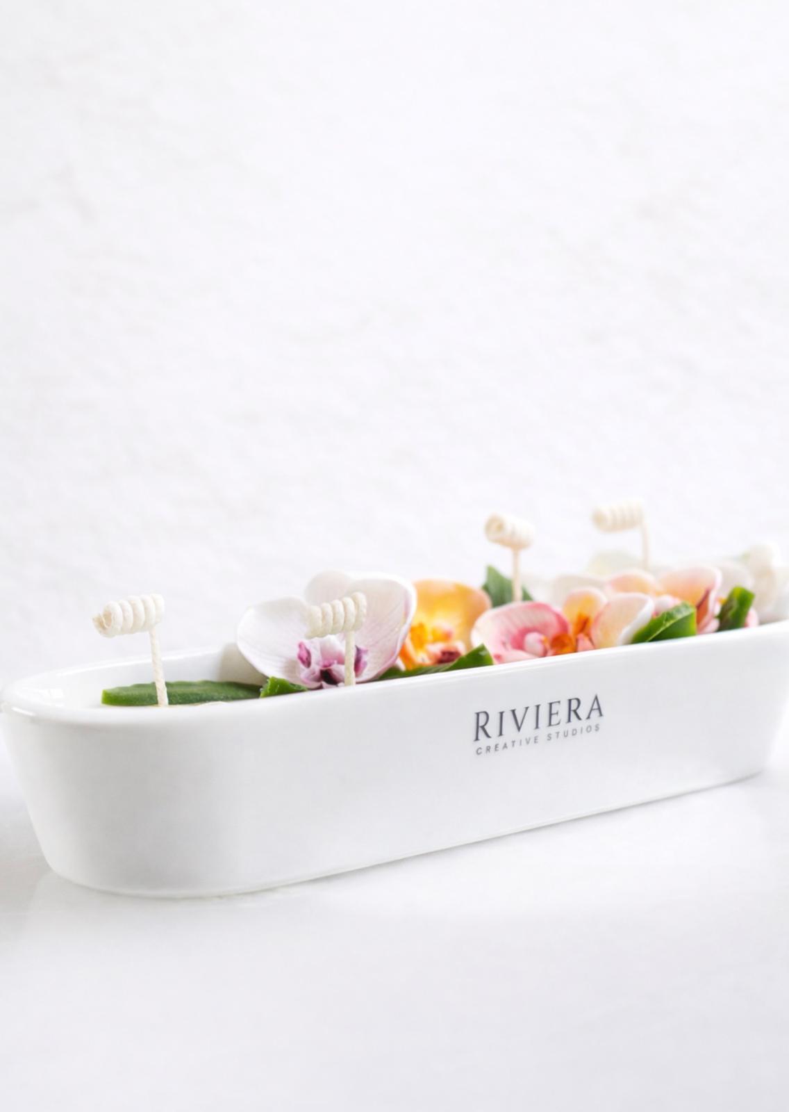 White rectangular planter with colorful flowers and decorative elements, labeled 'Riviera', on a white background.