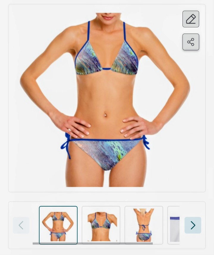 Woman in a colorful bikini with hands on hips, facing forward, against a white background.