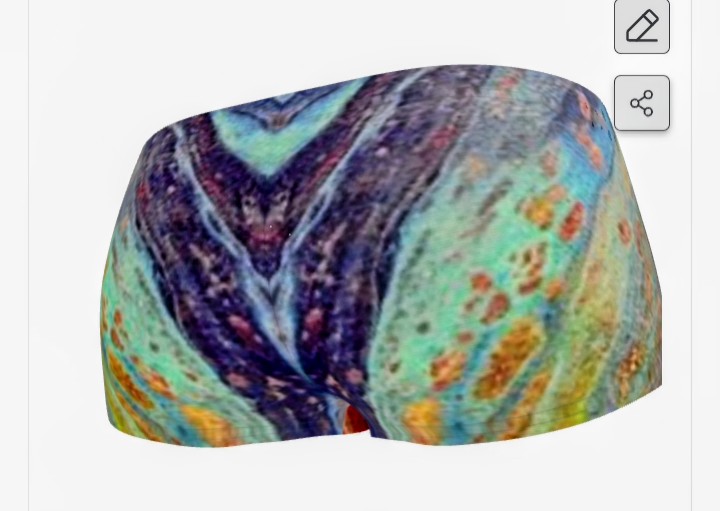 Colorful abstract pattern on fabric, with blue, green, orange, and purple hues, resembling a painted design.
