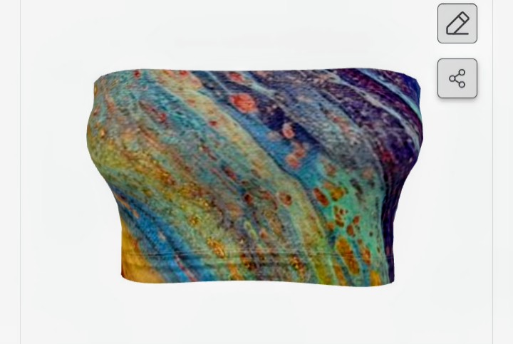 Colorful abstract pattern with blue, green, yellow, and orange streaks on fabric, textured surface.