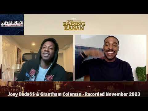 Two men are speaking in a video call, smiling, with a beige background and text overlay. One wears a hoodie, the other a black shirt.