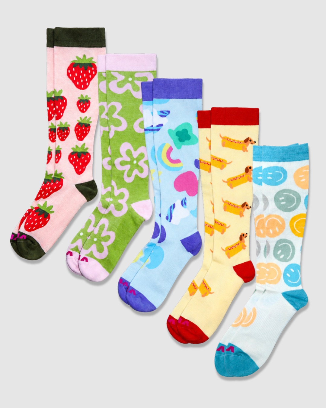 Five colorful socks with various patterns including strawberries, flowers, rainbows, tacos, and smiley faces, arranged vertically.