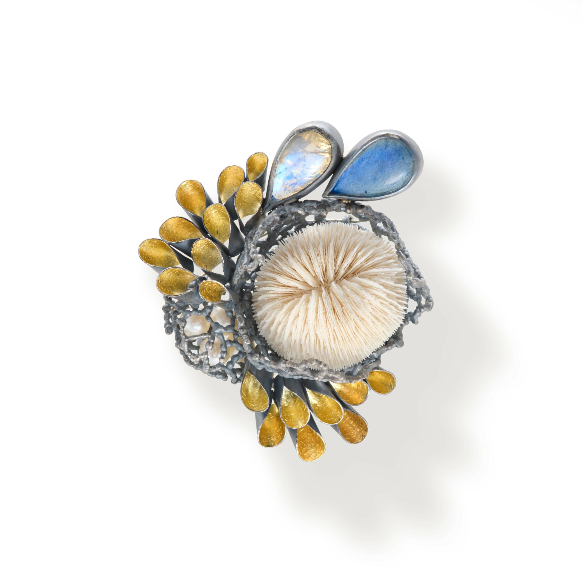 Decorative brooch with a central fabric flower, blue and gold accents, and intricate metalwork, on a white background.