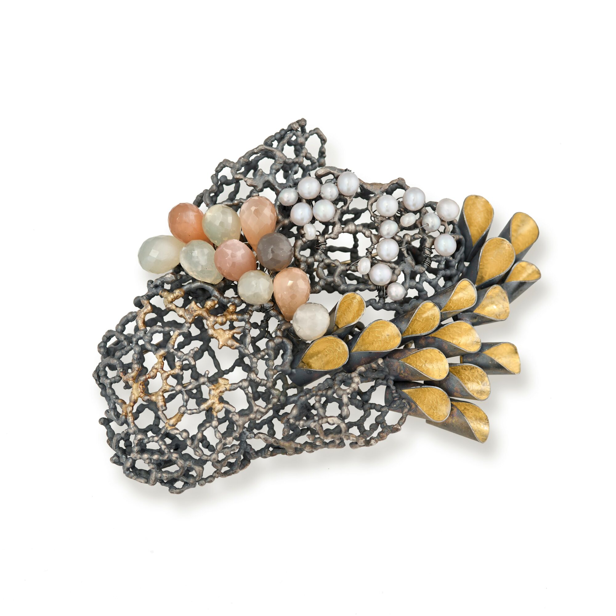 Decorative jewelry piece with black lace-like structure, pearls, and yellow teardrop-shaped beads, arranged in a cluster.
