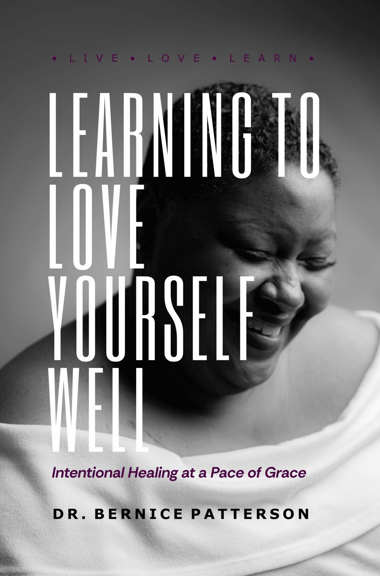 Black and white photo of a smiling person with closed eyes, wearing a white top, with text about learning to love oneself.