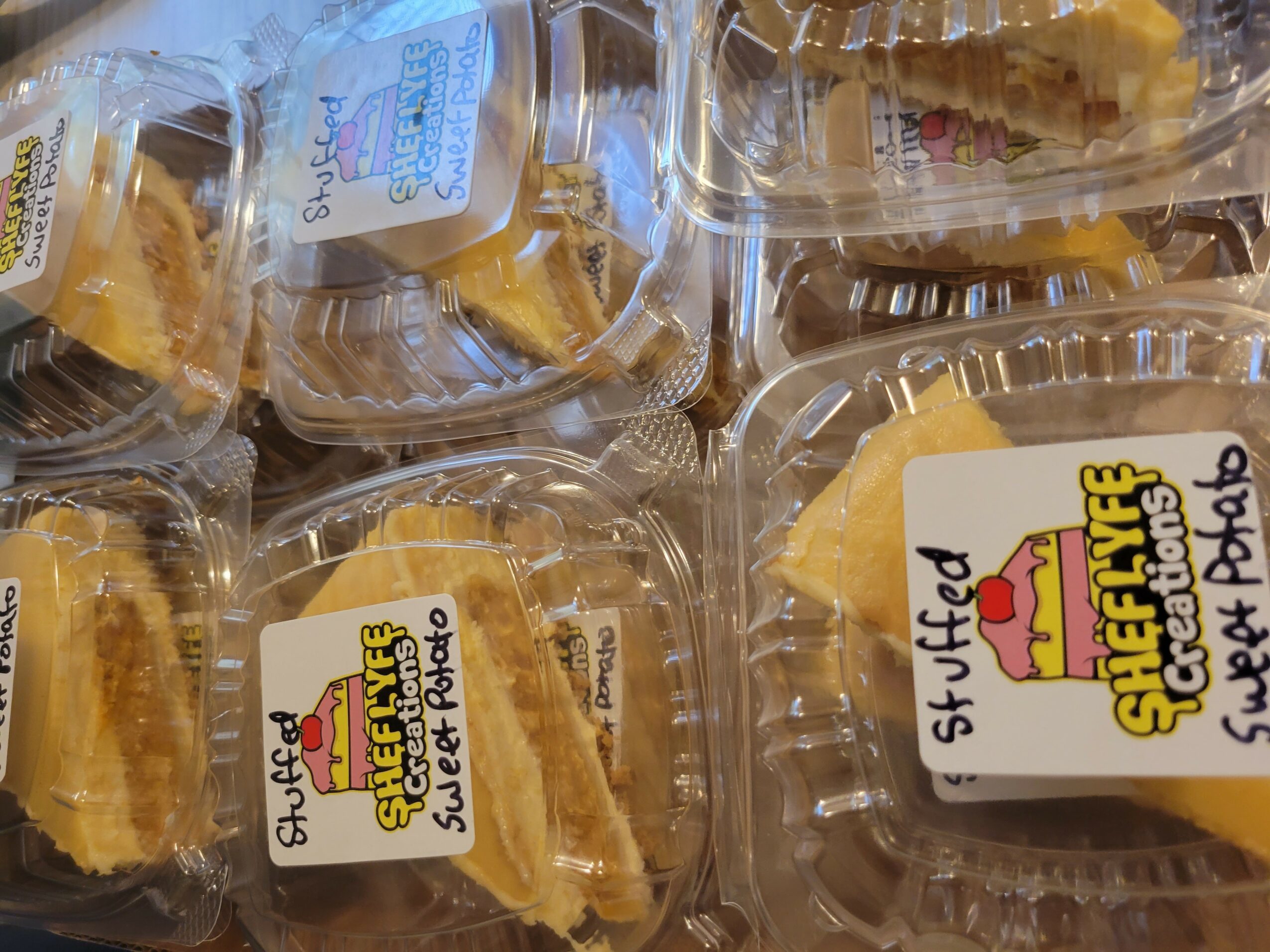 Clear plastic containers with slices of yellow cake, labeled with a sticker reading 'Sheffield Sweet Patches' and 'Sweet Patches'.