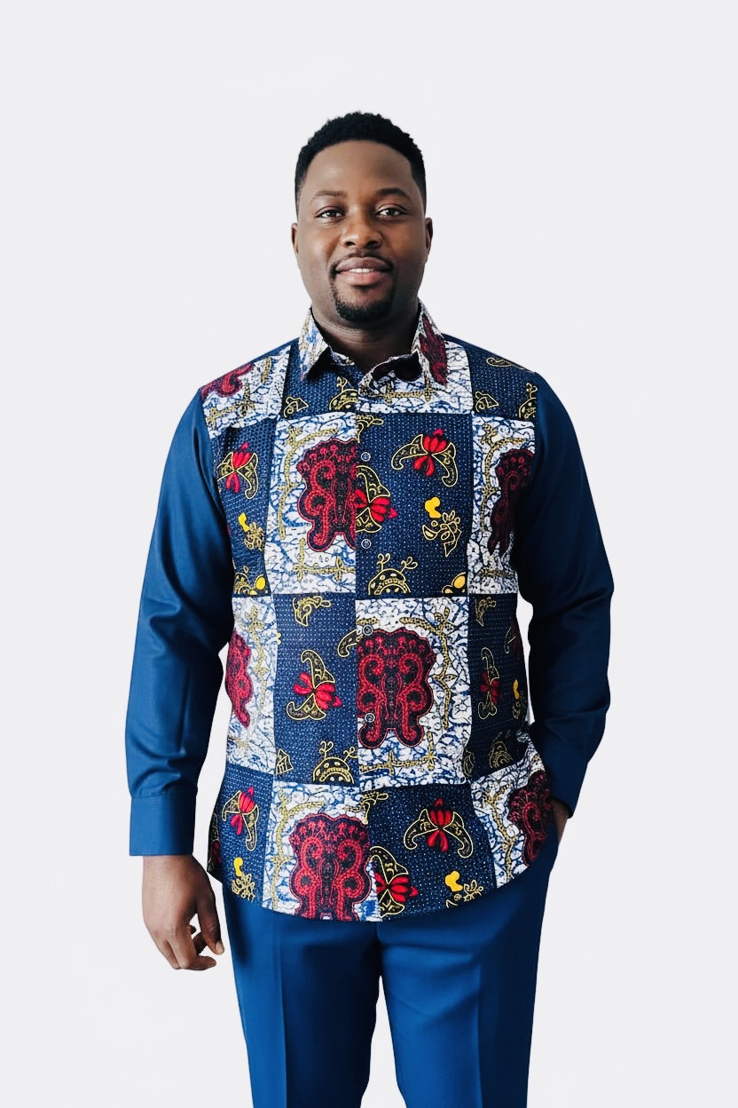 Man wearing a colorful patterned apron over a blue shirt, standing against a white background.