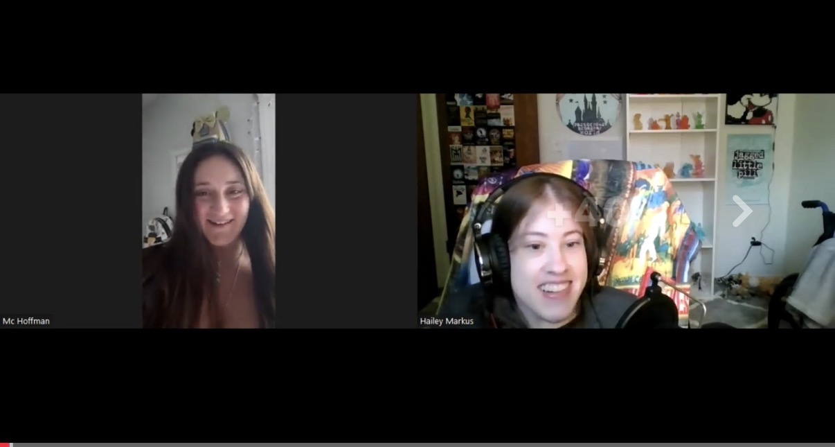 Two women smiling during a video call, one with long dark hair and the other with short hair and headphones, in a room with colorful decorations.
