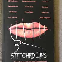 Close-up of stitched lips with white thread, black background, and names of people in red and white text above.