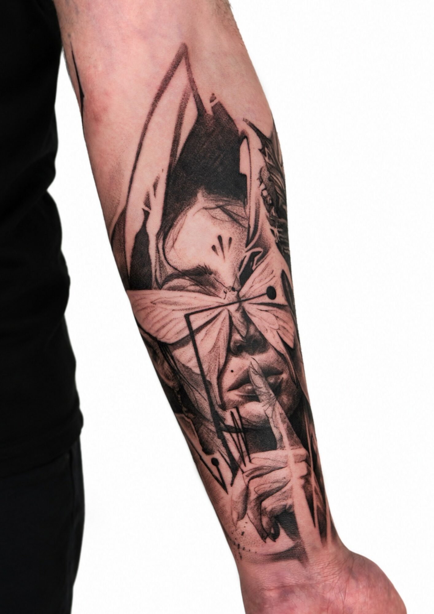 Black and gray tattoo of a woman with glasses, holding a finger to her lips, on forearm.